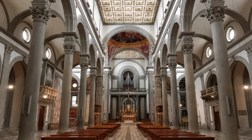 Interior of the Basilica of San Lorenzo in Florence with Renaissance columns, arches, and central altar