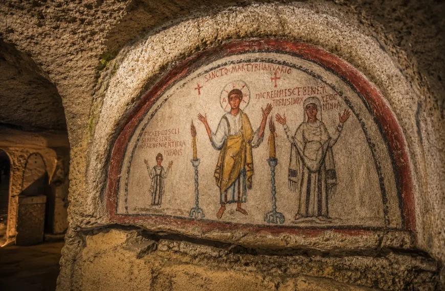 Ancient Christian fresco inside the Catacombs of San Gennaro in Naples featuring early religious artwork and underground stone architecture.