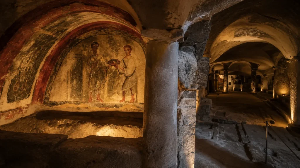 Early Christian fresco inside the Catacombs of San Gennaro in Naples with ancient religious artwork and underground basilica architecture