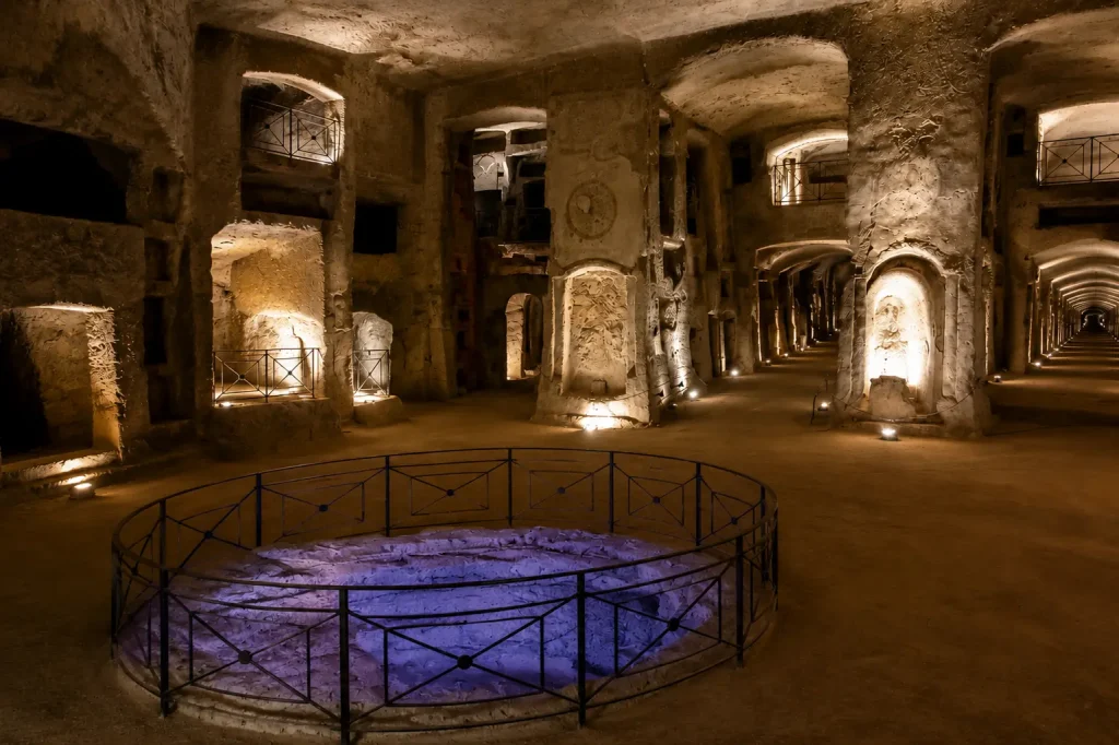 Grand underground hall inside the Catacombs of San Gennaro in Naples featuring ancient galleries, burial chambers, and Early Christian architecture