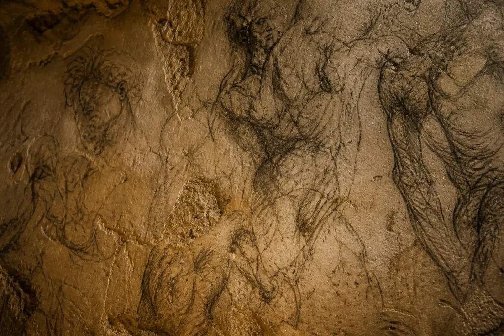 Interior of Michelangelo’s Secret Room beneath the Medici Chapels with charcoal sketches covering the walls in Florence, Italy