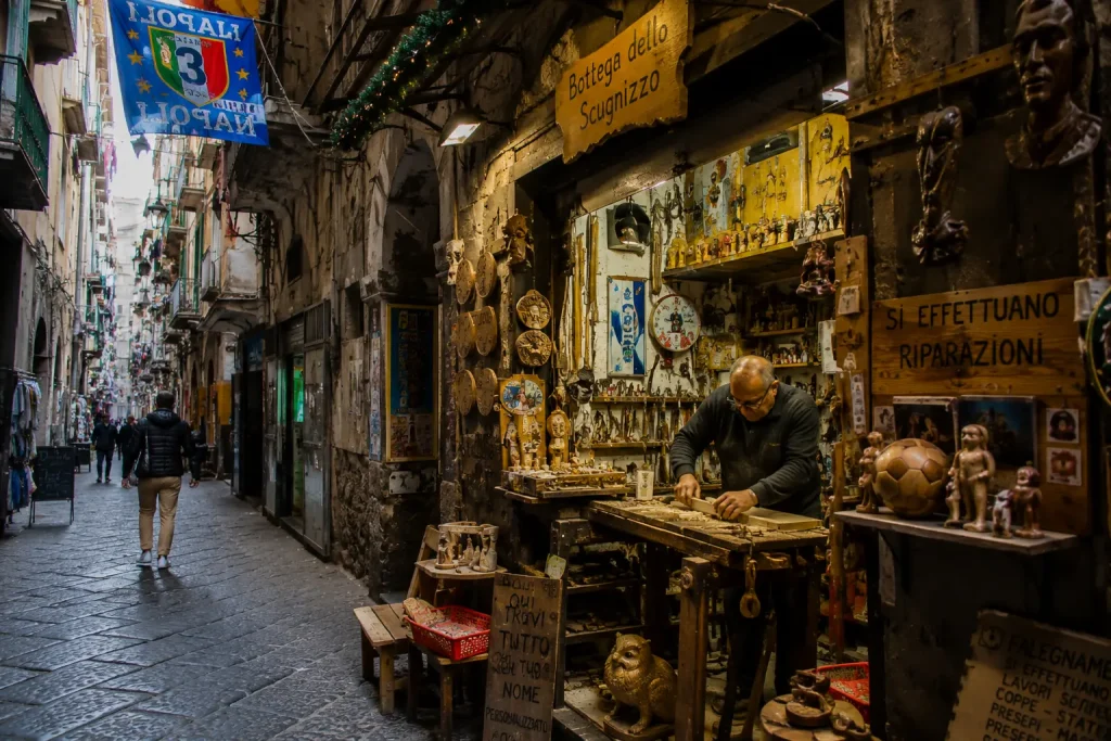 Traditional artisan workshop in Quartieri Spagnoli Naples with local craftsman working inside a small bottega