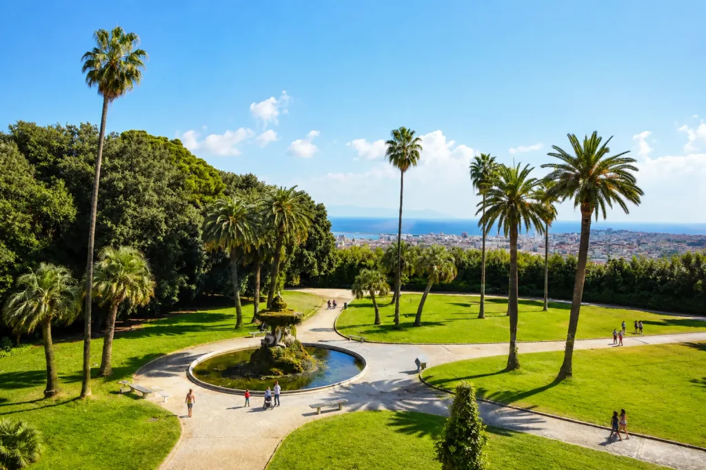Real Bosco di Capodimonte royal park in Naples with palm trees, fountain, and panoramic city views
