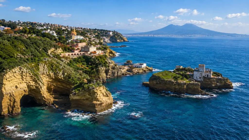 Aerial view of La Gaiola Island and the Posillipo coastline with Mount Vesuvius in the background, Naples, Italy